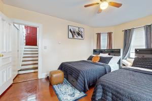 a bedroom with two beds and a stair case at 3 Mi to Franklin Park Zoo! Bright Residential Stay in Boston