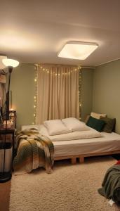 a bedroom with a large bed with lights on it at SPACE Guesthouse in Seoul