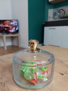 a glass jar filled with different colored candies on a table at Apartament Na Rynku in Bytom