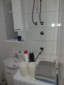 a small bathroom with a sink and a toilet at Apartment Victoria in Foča +4 photos