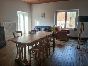 a living room with a wooden table and chairs at Avol d'Oiseau in Villers-Farlay