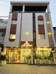 a hotel with a sign in front of a building at Hotel Casa Square in Indore