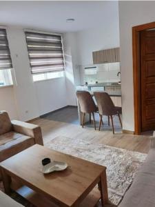 a living room with a couch and a table at Apartment Victoria in Foča