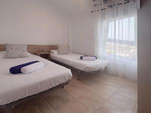 a bedroom with two beds and a window at Pablo House Beach in Telde +35 photos