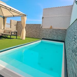 a swimming pool in the backyard of a house at Pablo House Beach in Telde