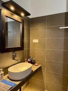 a bathroom with a sink and a mirror at The Tide's Tale in Galle
