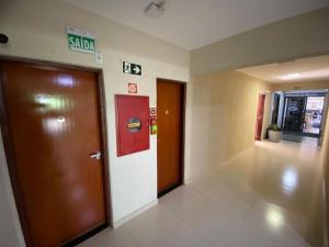 a hallway with two elevators in a building at Tawfiqs Hotel in Barra do Garças