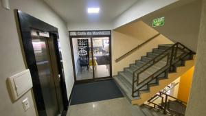 a hallway with a staircase in a building with a door at Tawfiqs Hotel in Barra do Garças