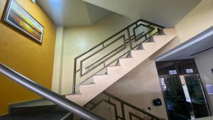 a spiral staircase in a building with a stair railing at Tawfiqs Hotel in Barra do Garças