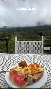 a plate of breakfast food on a table at Pousada Pe da Serra in Tiradentes