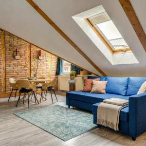 a living room with a blue couch and a table at ACME Apartments in Budapest