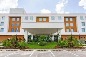 a large white building with a parking lot at Four Points by Sheraton Georgetown in Georgetown