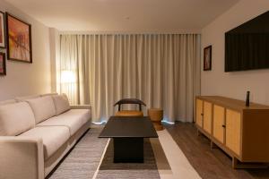 a living room with a couch and a table at Four Points by Sheraton Georgetown in Georgetown +47 photos