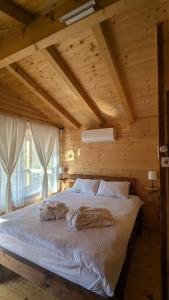 a bedroom with a large bed in a wooden room at Kompleks Etno Luks in Crvulevo +91 photos