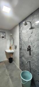 a bathroom with a shower and a sink and a tub at Flying Fox in Bangalore +52 photos