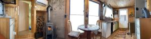 an internal view of a tiny house with a stove at Tiny House Anneliese, Klimaanlage, E-Bikes, Hunde ok in Oberbettingen