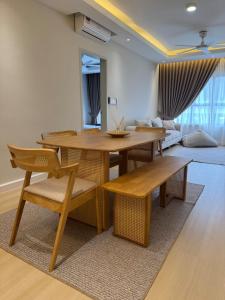 a living room with a table and chairs and a couch at InapByDaddy's Near KLIA SIC Sepang 4BR Fully Aircond in Sepang