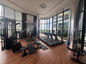 a gym with a row of treadmills and exercise equipment at TriZen Luxe Apartments in Colombo