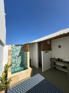 a bathroom with a bath tub on the side of a house at BaleiaLofts Kite Village in Itapipoca