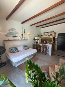 a living room with a bed and a table at BaleiaLofts Kite Village in Itapipoca