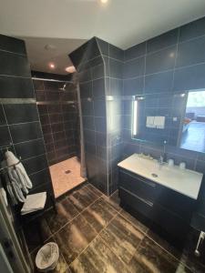 a bathroom with a sink and a shower with blue tiles at U Sant'Agnellu in Rogliano +69 photos
