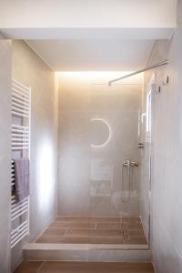 a bathroom with a shower with a glass door at Tailor Garden House in Tríkala +12 photos