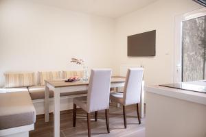 a kitchen and dining room with a table and chairs at Tailor Garden House in Tríkala