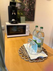 a table with two bottles of water and a microwave at Ferienwohnung Rhöner Luft in Bad Brückenau +20 photos