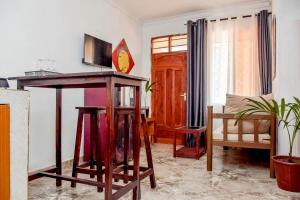 a living room with a table and a couch at Kilifi Tulivu in Kilifi