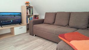 a living room with a couch and a flat screen tv at Ferienwohnung Helene in Munster