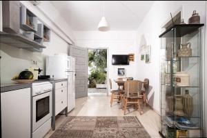 a kitchen with white appliances and a dining room at New! Paxosblue suites sea view with private pool in Gaios