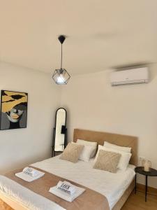 a bedroom with a large bed with white sheets at Danin apartmani in Bar +54 photos