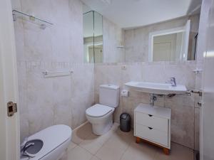 a bathroom with a toilet and a sink at Apartamento Gema Gemelos 26 in Benidorm +19 photos