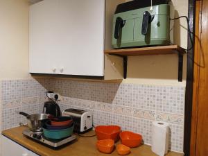 a kitchen counter with a toaster and pots and pans at Self contained 1 bedroomed garden flat in Abersychan