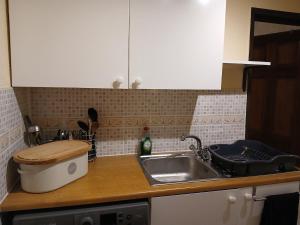 a kitchen with a sink and a counter top at Self contained 1 bedroomed garden flat in Abersychan