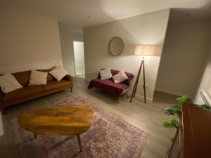 a living room with a couch and a chair at St Magnus Retreat in Lerwick