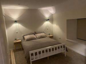 a bedroom with a bed and a flat screen tv at St Magnus Retreat in Lerwick +4 photos
