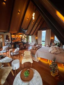 a large room with a large bed and a living room at Chalé RIVAGI in Passa Quatro +52 photos