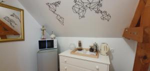 a small kitchen with a sink and a microwave at Maison des Hortensias in Saint-Contest