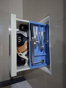 a cupboard with utensils in it at Little Blue House- AoNang in Ao Nang 