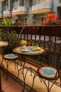 a table and two chairs on a balcony at the L Hua Hin in Hua Hin