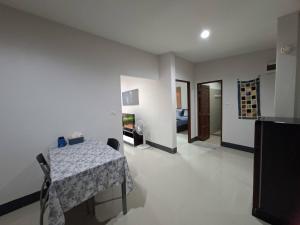 a living room with a table and a room with a bedroom at Little Blue House- AoNang in Ao Nang 