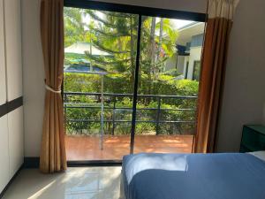 a bedroom with a large window with a view at Little Blue House- AoNang in Ao Nang 