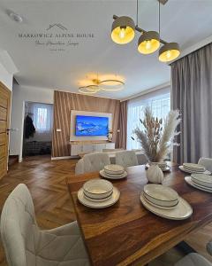 a living room with a dining room table with chairs at Markowicz Alpine House in Szaflary