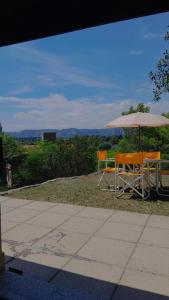 a table and chairs under an umbrella with a view at Chalet Doña Ines in Cuesta Blanca