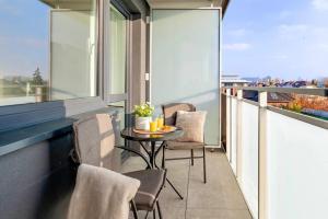 a balcony with chairs and a table on a balcony at SPV Rentals Pileckiego 59 lokal 226 free Parking Ursynów in Warsaw