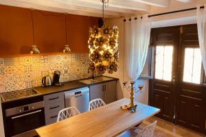 a kitchen with a wooden table and a dining room at Ruime cortijo met zwembad in Andalusië ideaal voor families & groepen 3 appartementen in Huércal-Overa