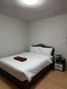 a bedroom with a white bed with a brown towel on it at Greenview Room and Restaurant in Ko Yao Yai