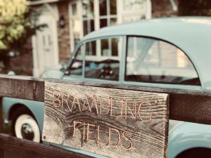 a sign on a fence that reads breaking habits at Brambling Fields B&B and Cottages in Malton