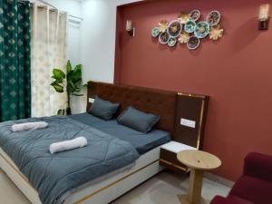 a bedroom with a bed with two towels on it at Kremlin Luxury Studios in Ghaziabad
